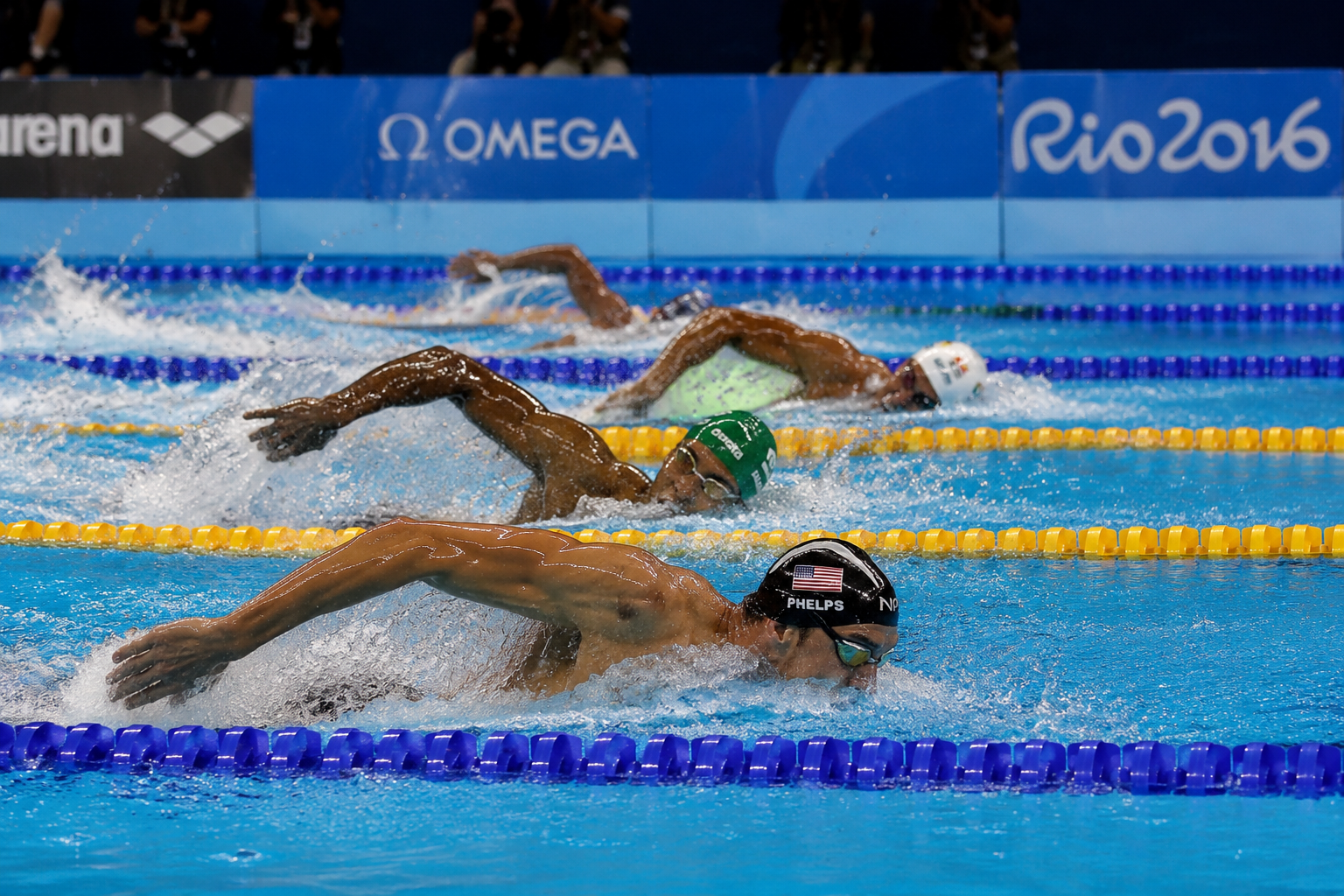 Professional swimmer diving off starting block